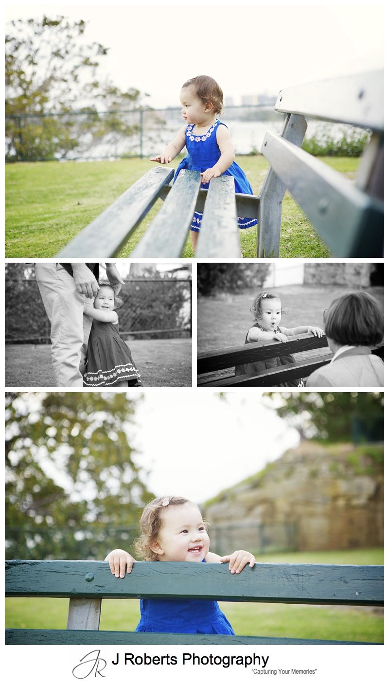 Little girl playing peek a boo with park bench - sydney family portrait photographer